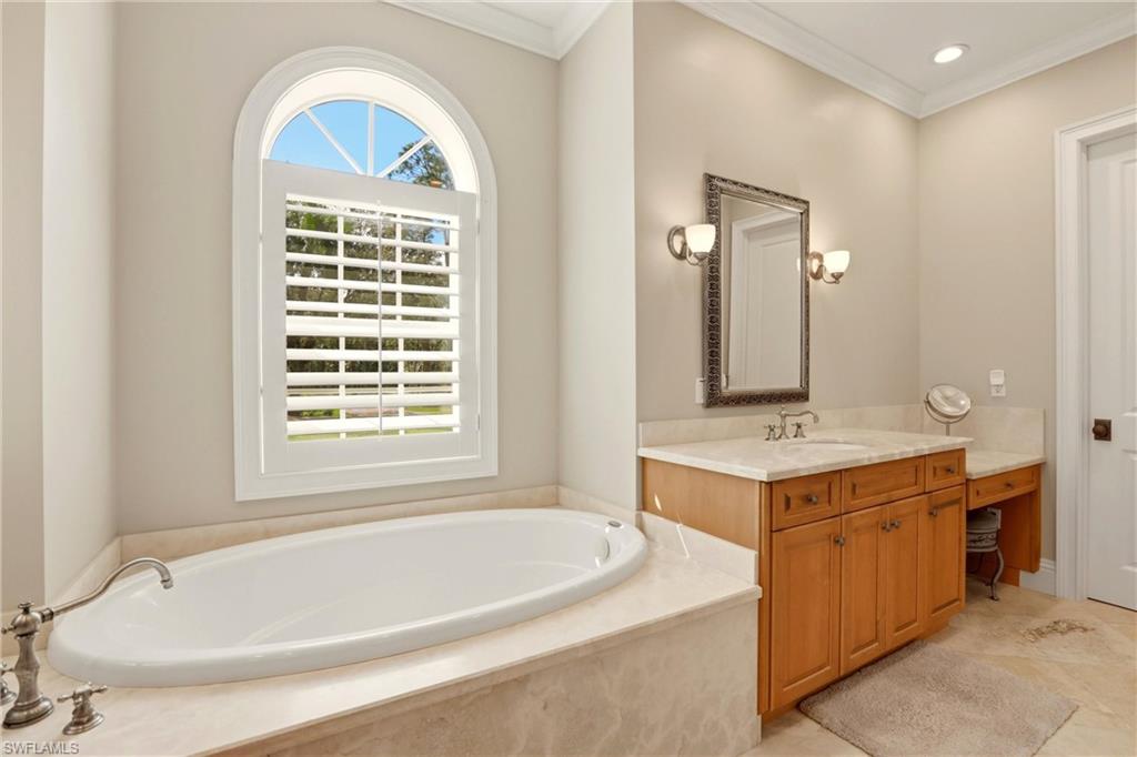 4335 7th Avenue Southwest Naples, FL 34119 - Photo 23 of 49 Bathroom with vanity, crown molding, a bath, and recessed lighting