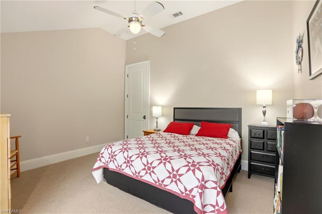 4335 7th Avenue Southwest Naples, FL 34119 - Photo 30 of 49 Bedroom with lofted ceiling, light colored carpet, and a ceiling fan