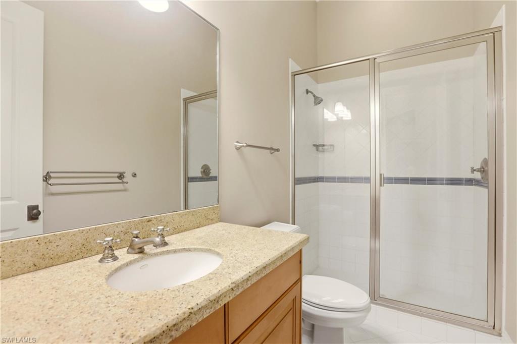 4335 7th Avenue Southwest Naples, FL 34119 - Photo 31 of 49 Bathroom featuring vanity and a stall shower