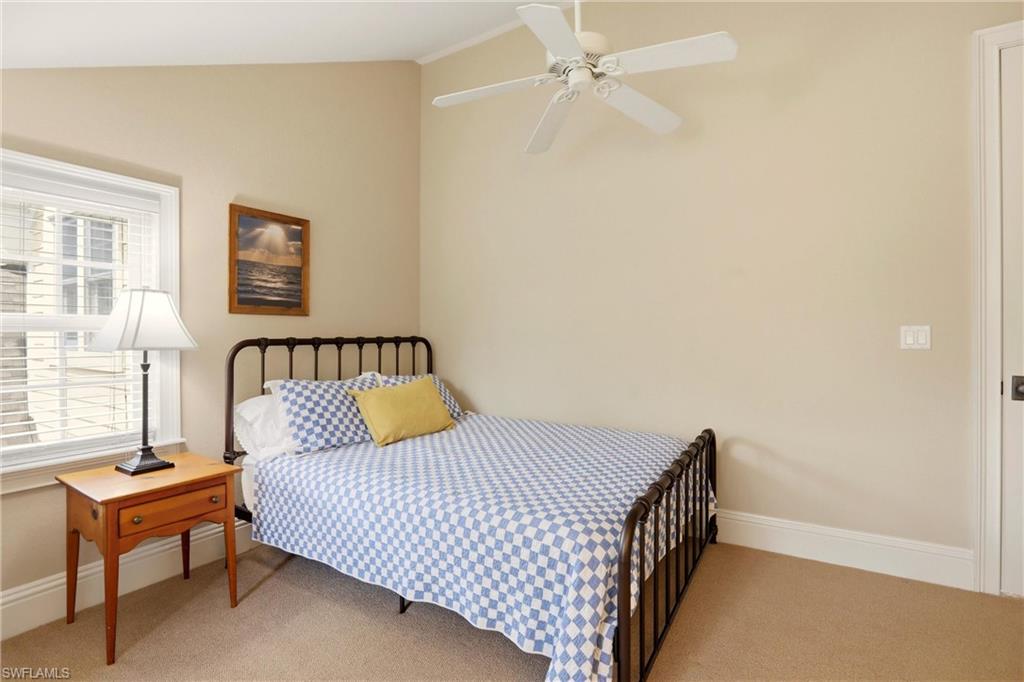 4335 7th Avenue Southwest Naples, FL 34119 - Photo 32 of 49 Bedroom with light colored carpet, ceiling fan, and lofted ceiling