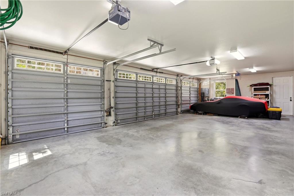 4335 7th Avenue Southwest Naples, FL 34119 - Photo 37 of 49 Garage with a garage door opener