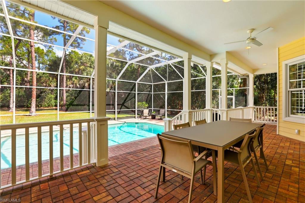 4335 7th Avenue Southwest Naples, FL 34119 - Photo 38 of 49 Swimming pool with a sunroom, a patio, glass enclosure, and outdoor dining area