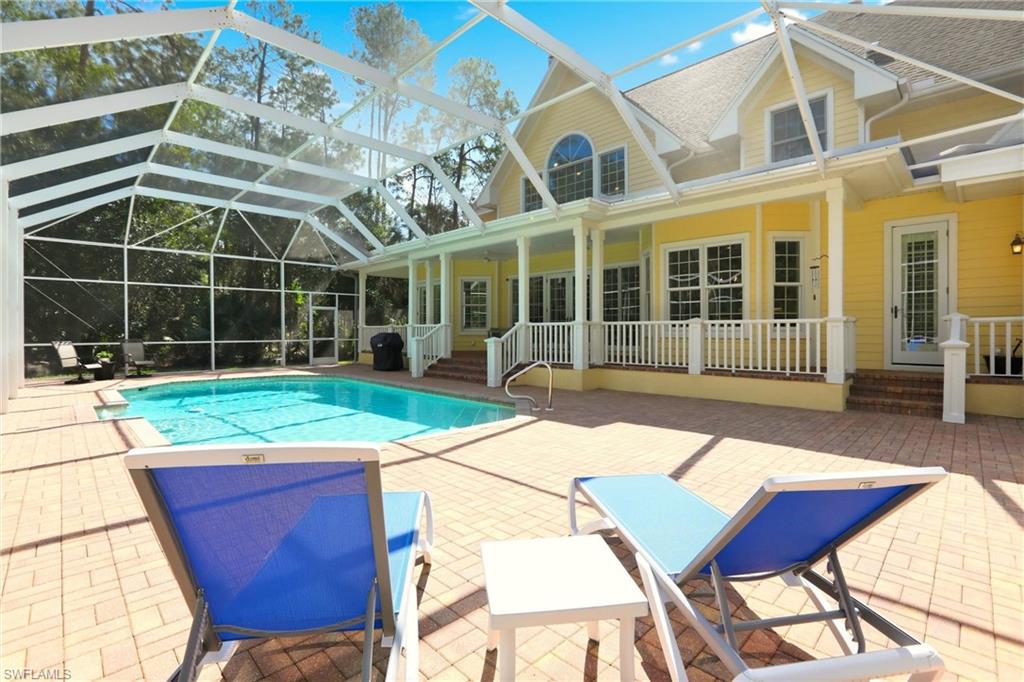 4335 7th Avenue Southwest Naples, FL 34119 - Photo 39 of 49 Outdoor pool with a patio area, a sunroom, and glass enclosure