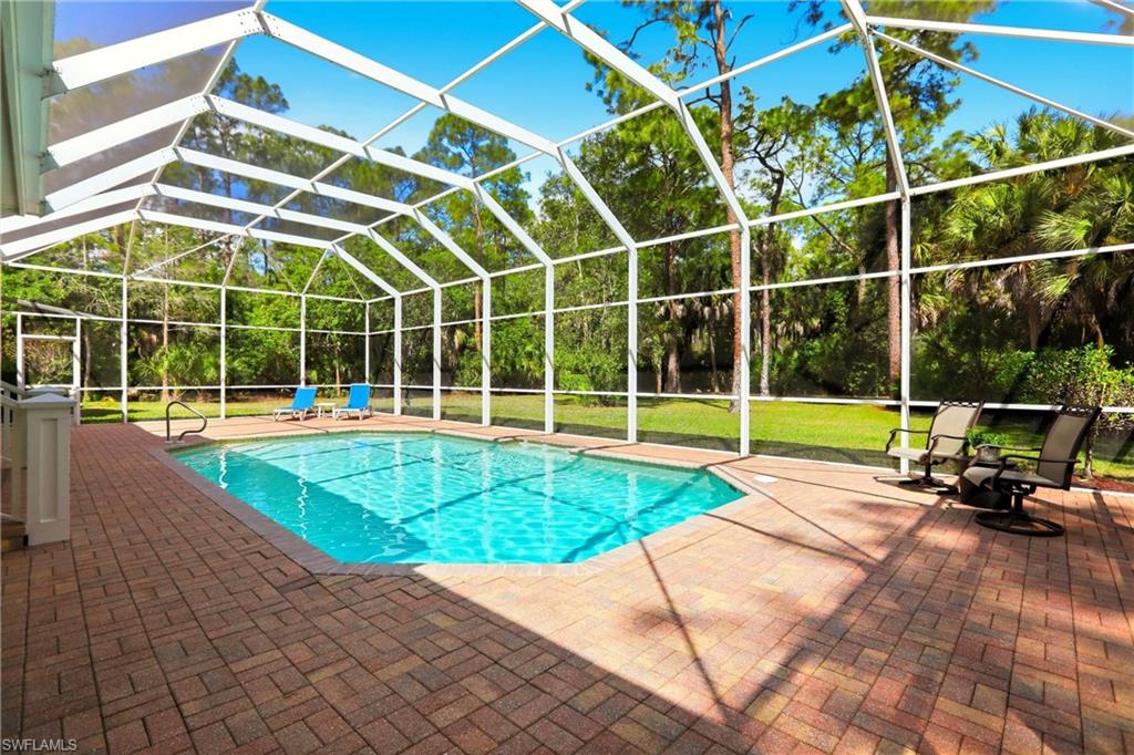 4335 7th Avenue Southwest Naples, FL 34119 - Photo 40 of 49 Outdoor pool with a lanai, a sunroom, and a patio area