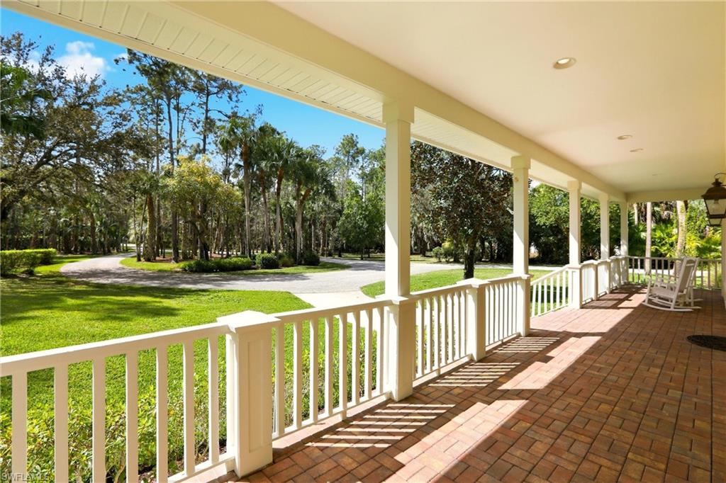 4335 7th Avenue Southwest Naples, FL 34119 - Photo 4 of 49 Wooden porch with a lawn