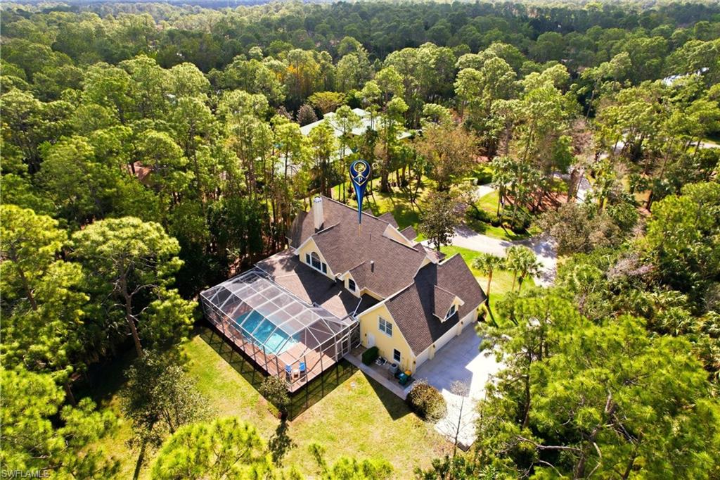 4335 7th Avenue Southwest Naples, FL 34119 - Photo 45 of 49 View from above of property featuring a forest