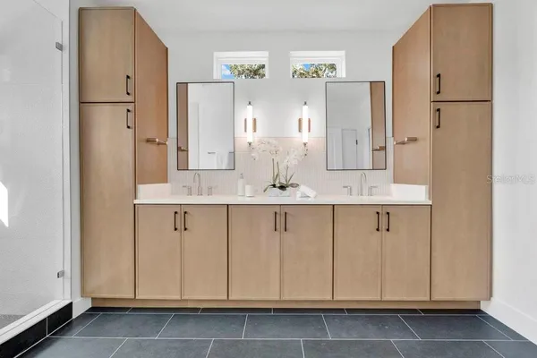 a spacious bathroom with a double vanity sink and a mirror