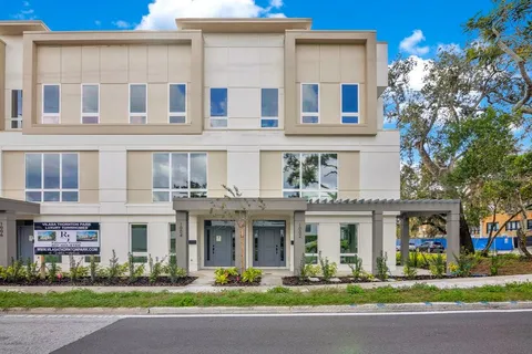 a living room with furniture and large windows