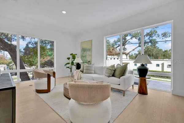 a living room with furniture and a potted plant