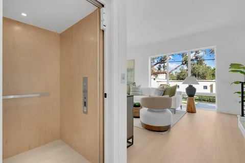 a dining hall with stainless steel appliances kitchen island granite countertop furniture and a view of kitchen