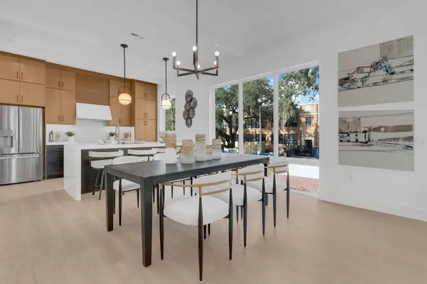 a kitchen with refrigerator cabinets and dining table