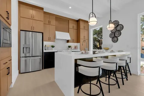 a kitchen with stainless steel appliances granite countertop a stove and a sink