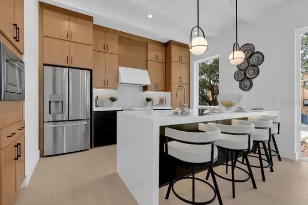 a kitchen with stainless steel appliances granite countertop a stove and a sink