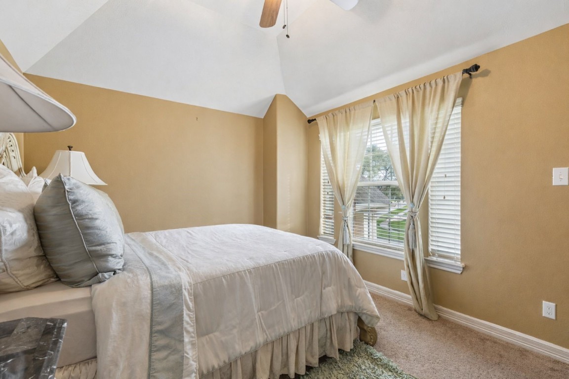 8211 Paddle Rock Lane Rosenberg, TX 77469 - Photo 13 of 24 a bedroom with a bed and a window