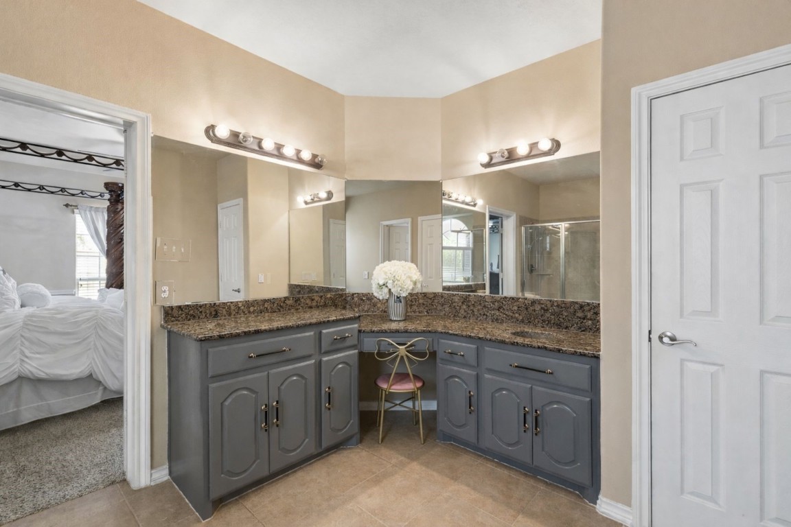 8211 Paddle Rock Lane Rosenberg, TX 77469 - Photo 14 of 24 a spacious bathroom with a granite countertop sink and a mirror