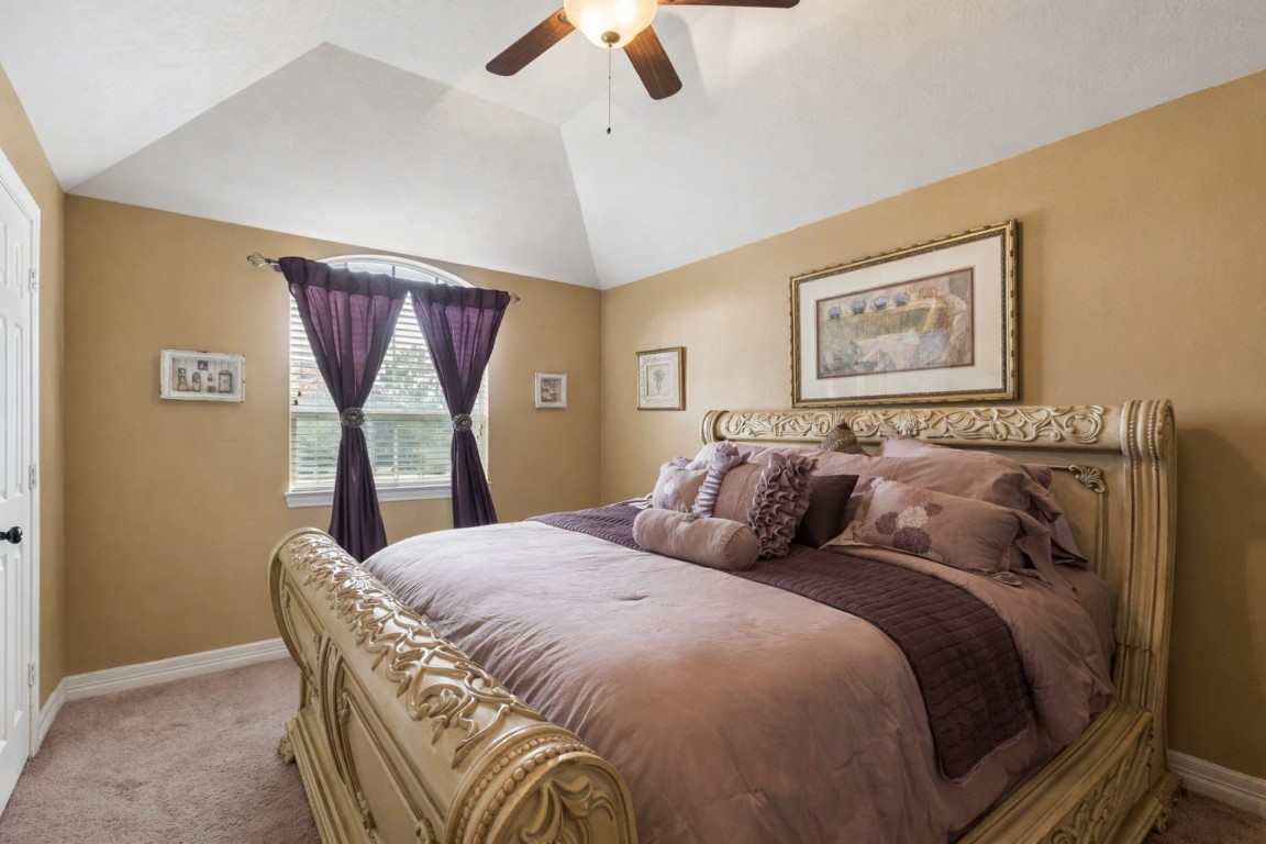 8211 Paddle Rock Lane Rosenberg, TX 77469 - Photo 17 of 24 a bed sitting in a bedroom next to a window