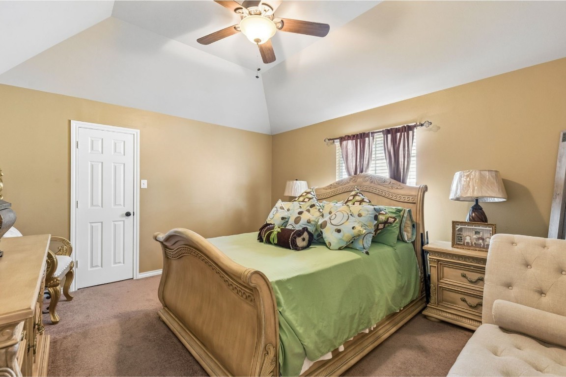 8211 Paddle Rock Lane Rosenberg, TX 77469 - Photo 19 of 24 a bedroom with a bed and a chandelier