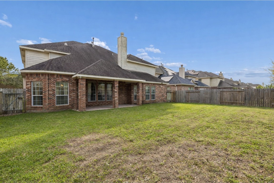 8211 Paddle Rock Lane Rosenberg, TX 77469 - Photo 20 of 24 a front view of a house with garden