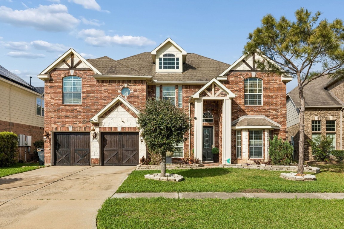 8211 Paddle Rock Lane Rosenberg, TX 77469 - Photo 2 of 24 front view of a house with a yard