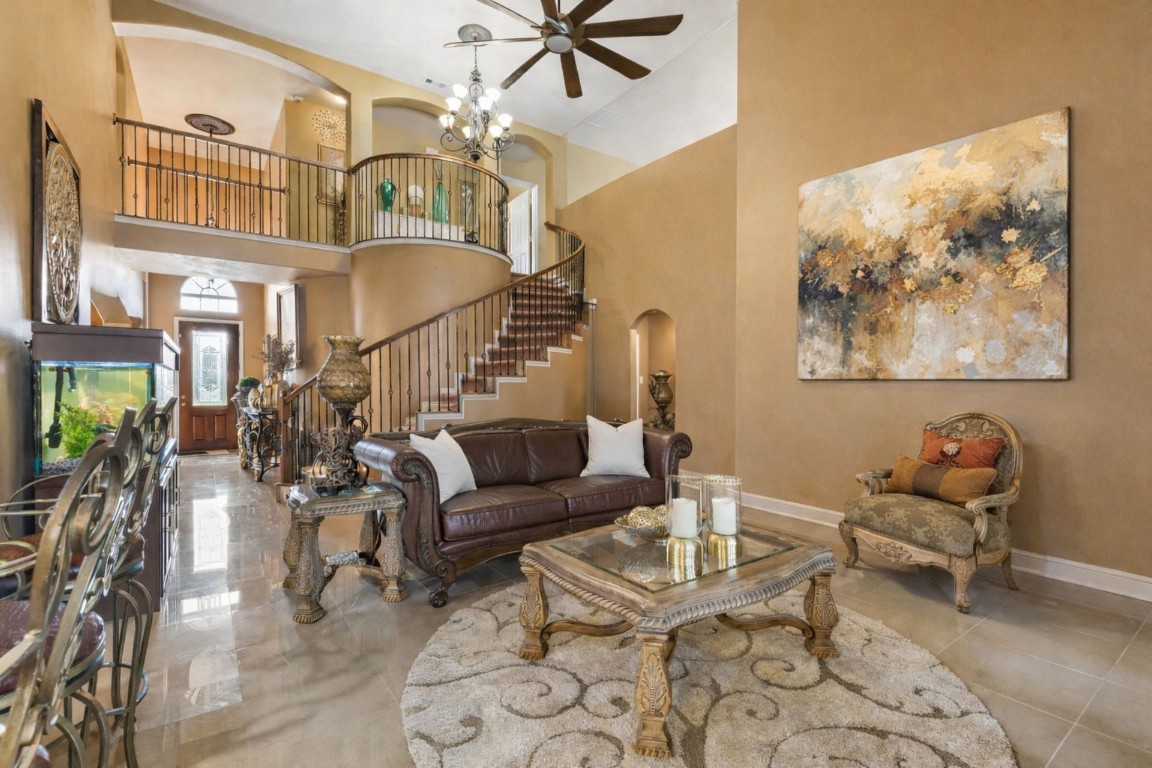 8211 Paddle Rock Lane Rosenberg, TX 77469 - Photo 5 of 24 a living room with furniture a rug and a chandelier