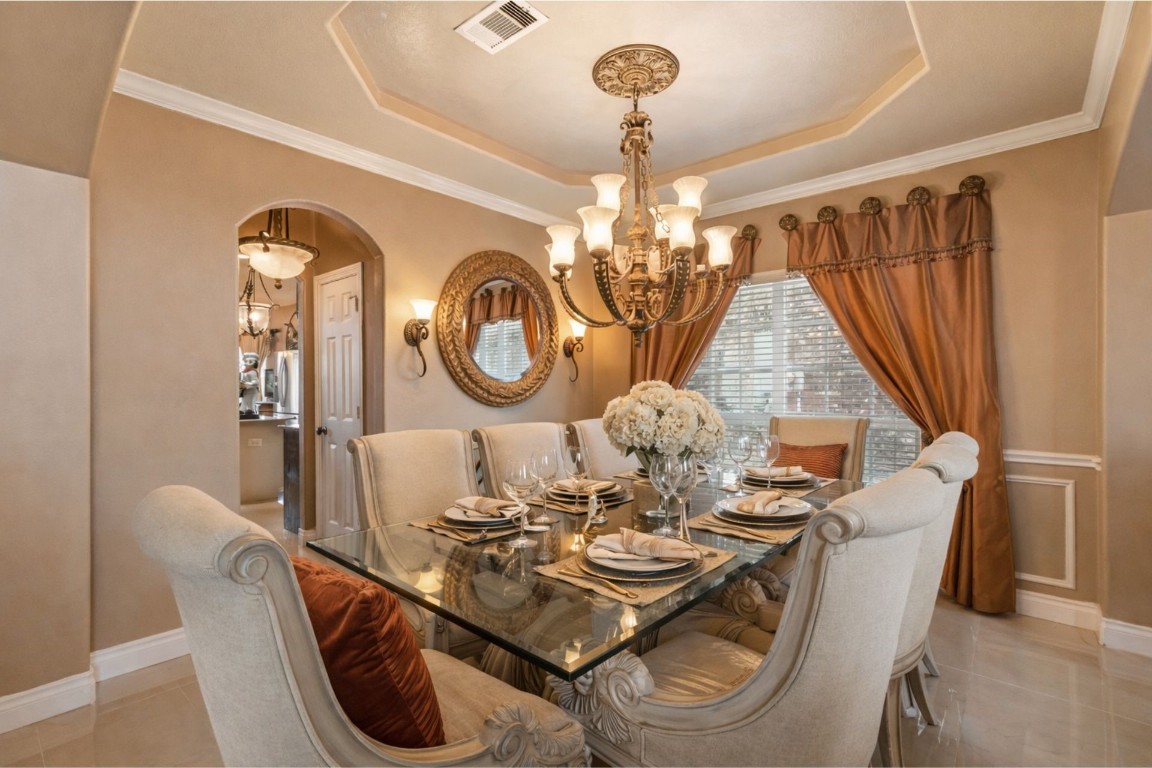 8211 Paddle Rock Lane Rosenberg, TX 77469 - Photo 8 of 24 a view of a dining room with furniture and chandelier