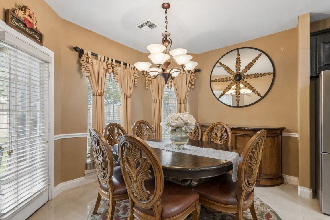 8211 Paddle Rock Lane Rosenberg, TX 77469 - Photo 10 of 24 a view of a dining room with furniture and chandelier