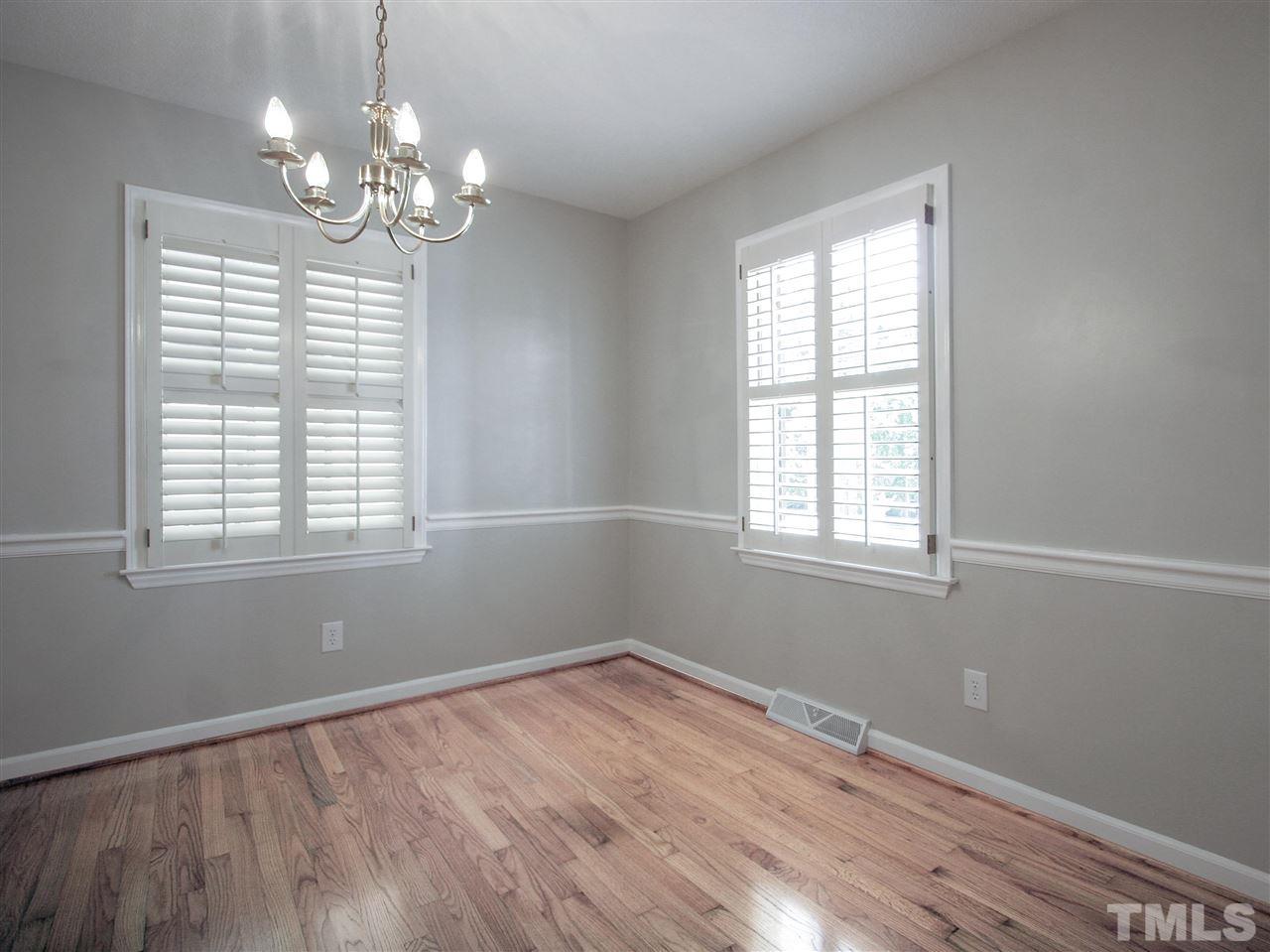1324 Kingston Ridge Road Cary, NC 27511 - Photo 14 of 30 Formal dining room has chair rail and 5-bulb light fixture. Note the Plantation shutters and gleaming hardwood floor.