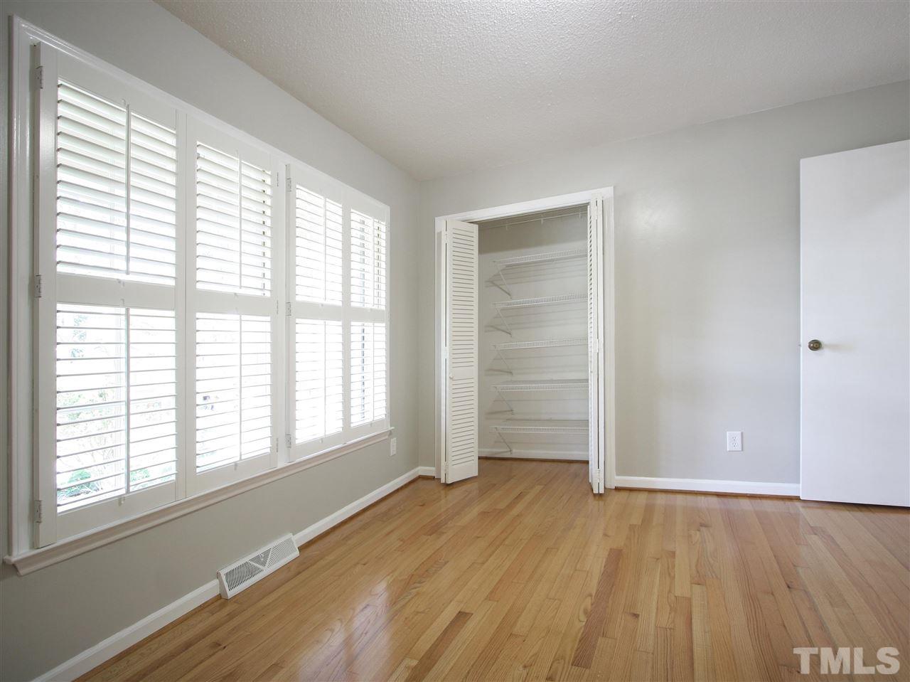 1324 Kingston Ridge Road Cary, NC 27511 - Photo 16 of 30 Bedroom #2 is at the center front of the home and features hardwood floor, double windows with Plantation shutters, and closet with wire shelving.