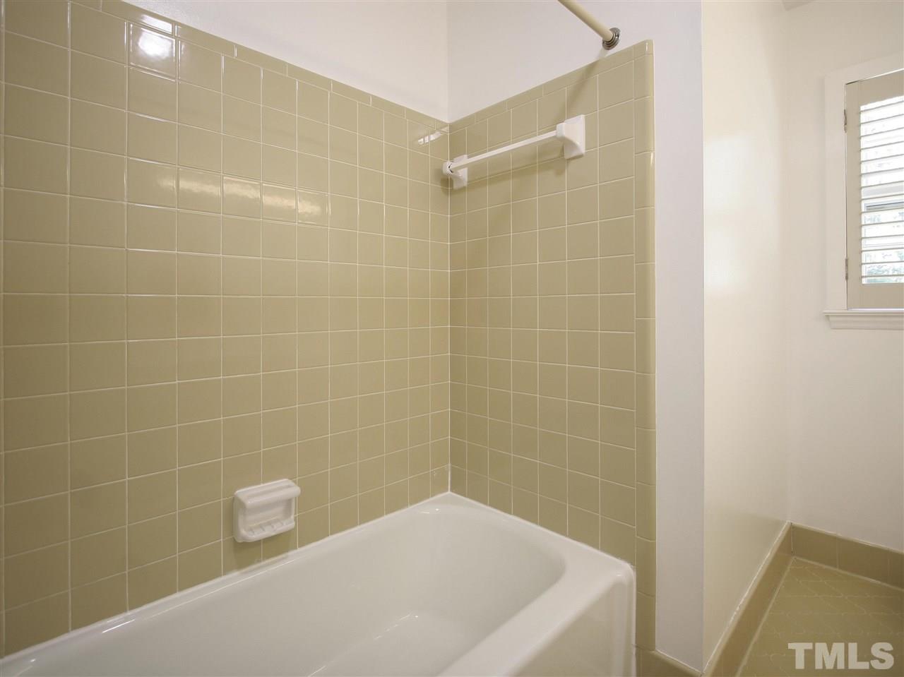 1324 Kingston Ridge Road Cary, NC 27511 - Photo 19 of 30 This view of the hall bath shows the tub/shower with tile surround.