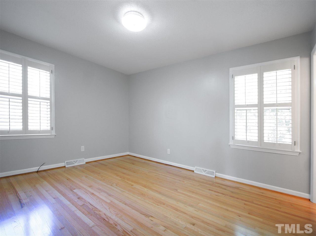 1324 Kingston Ridge Road Cary, NC 27511 - Photo 21 of 30 The owner's suite bedroom is at the back of the home and features windows on two walls.