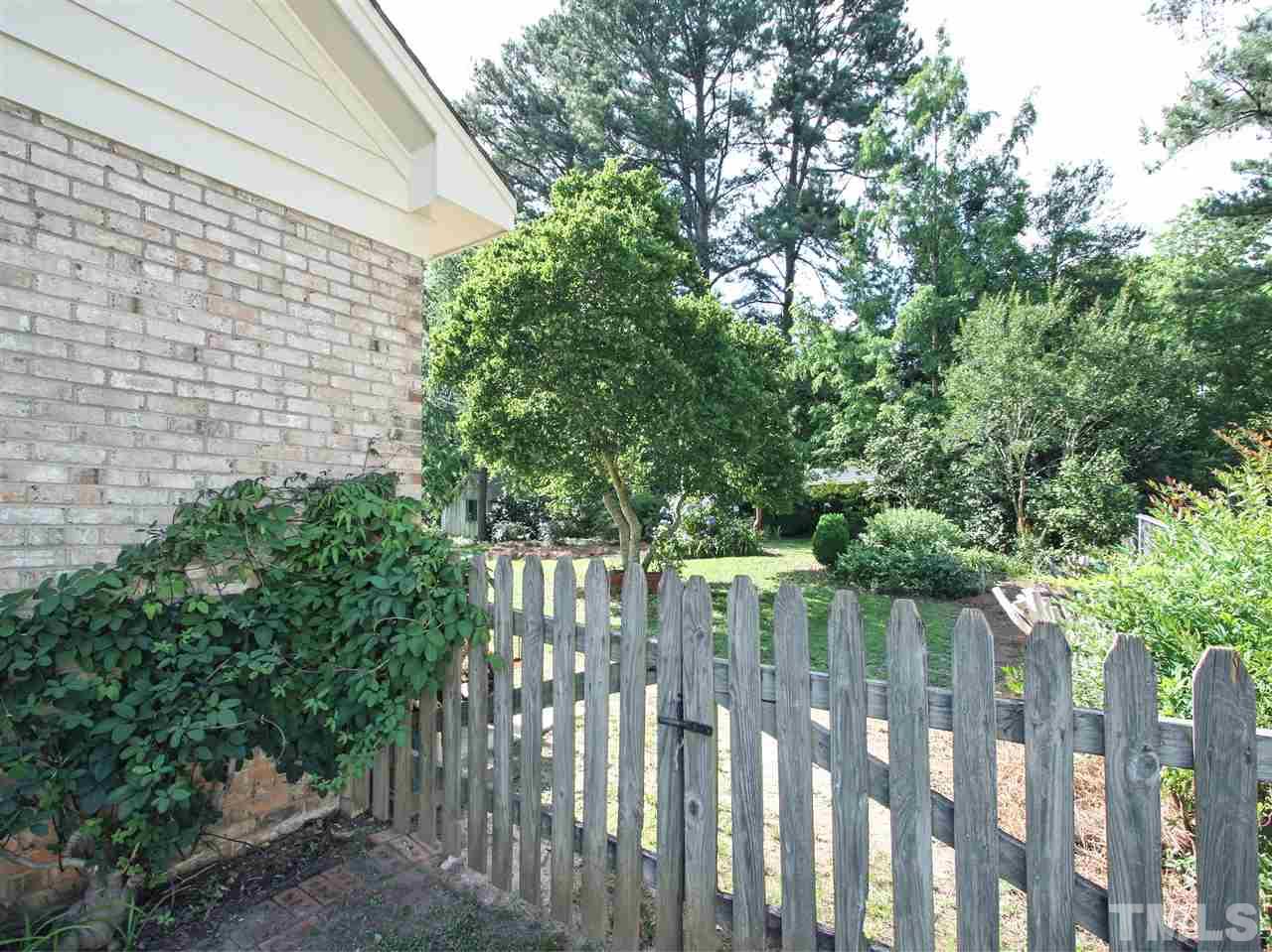 1324 Kingston Ridge Road Cary, NC 27511 - Photo 23 of 30 Garage has new overhead door. Great spot for your car or maybe a workshop. Door at right in the photo leads to a nice-size storage room. Door at the left leads into the house. Double window with Planation shutters brings in natural light.