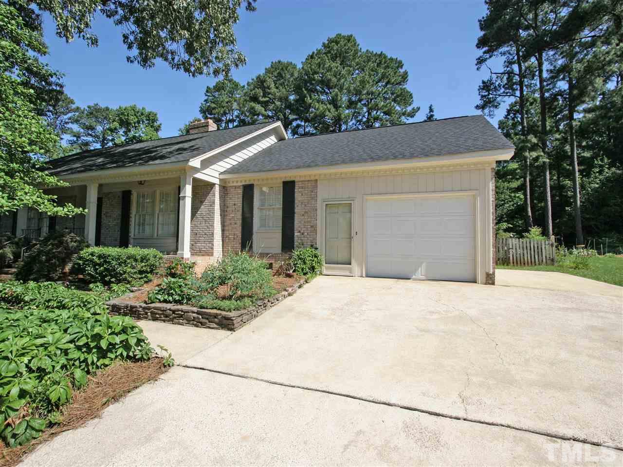 1324 Kingston Ridge Road Cary, NC 27511 - Photo 4 of 30 Oversized 1-car garage has new overhead door. Be sure to check out the storage room in the garage. There is a parking pad to the side, as well as plenty of driveway parking space for family and friends.