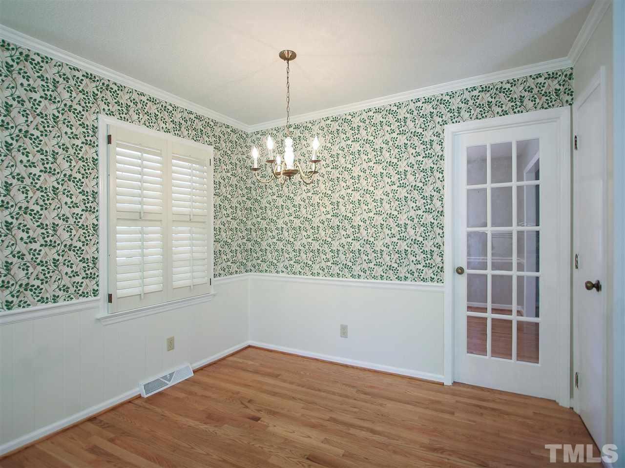 1324 Kingston Ridge Road Cary, NC 27511 - Photo 8 of 30 Cheerful breakfast area has wainscot and hardwood floor. 15-panel glass door leads to the formal dining room.