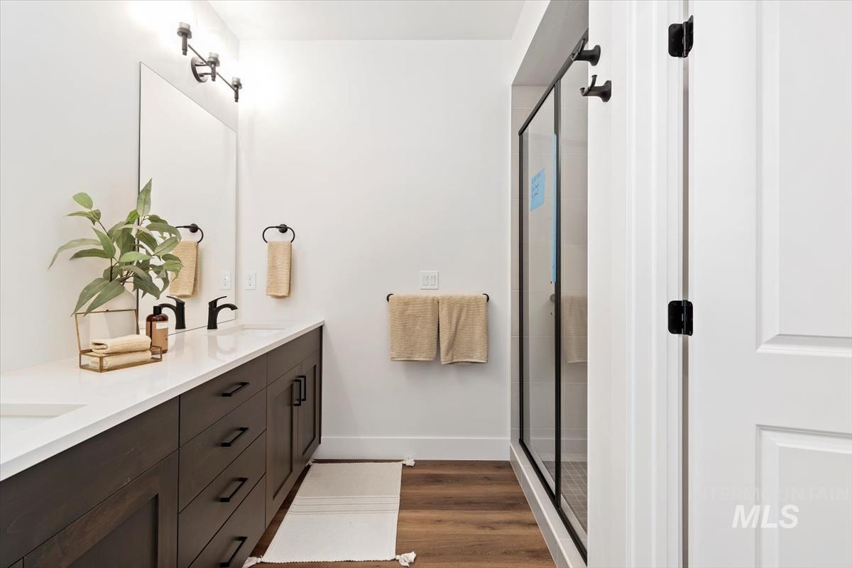 720 South Calhoun Place Star, ID 83669 - Photo 26 of 43 Full bathroom with double vanity, a shower stall, and dark wood finished floors