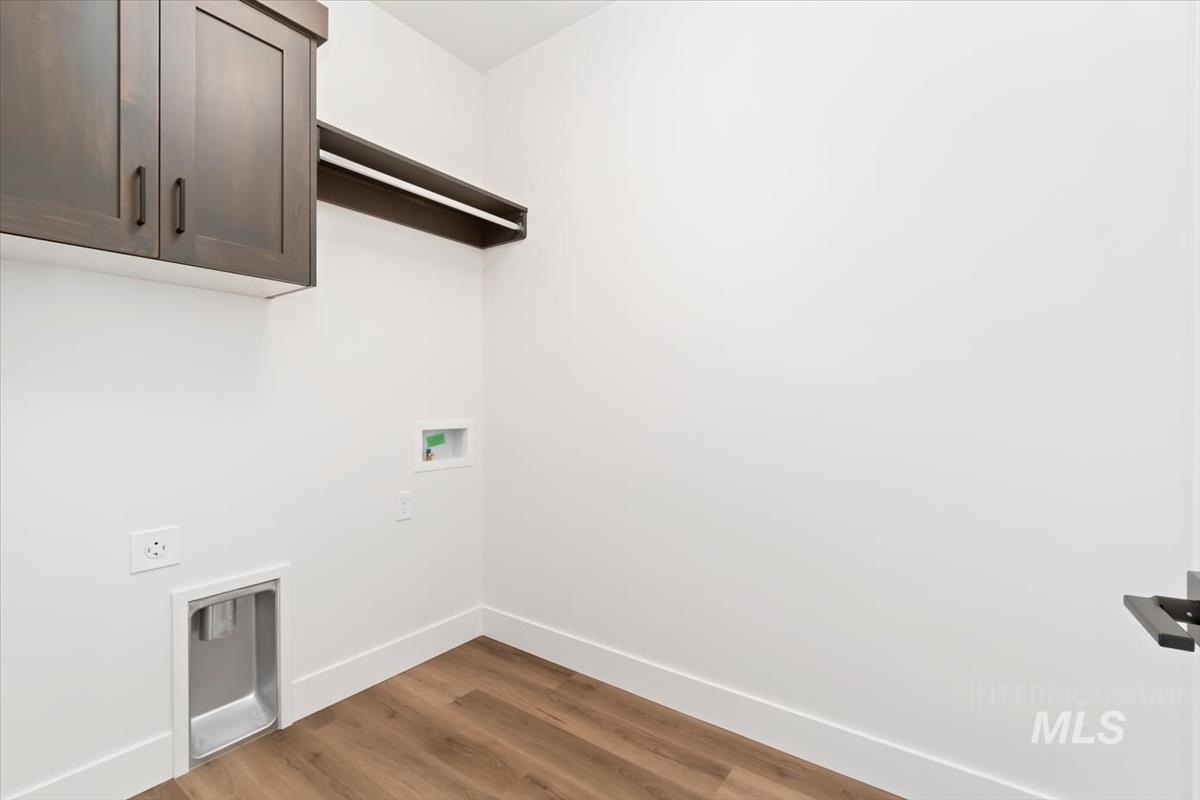 720 South Calhoun Place Star, ID 83669 - Photo 28 of 43 Washroom with wood finished floors, cabinet space, washer hookup, and hookup for an electric dryer