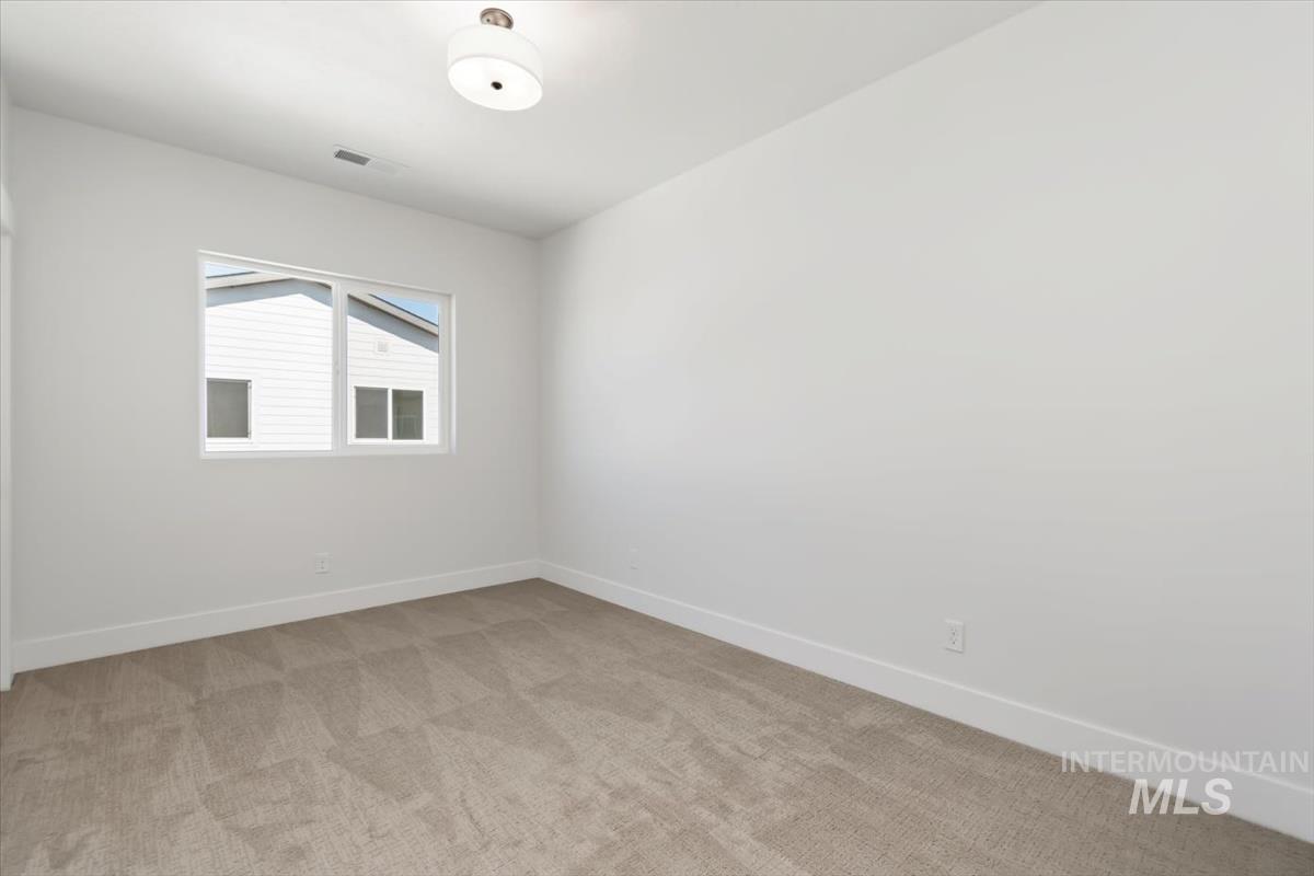 720 South Calhoun Place Star, ID 83669 - Photo 29 of 43 Empty room with baseboards and light carpet