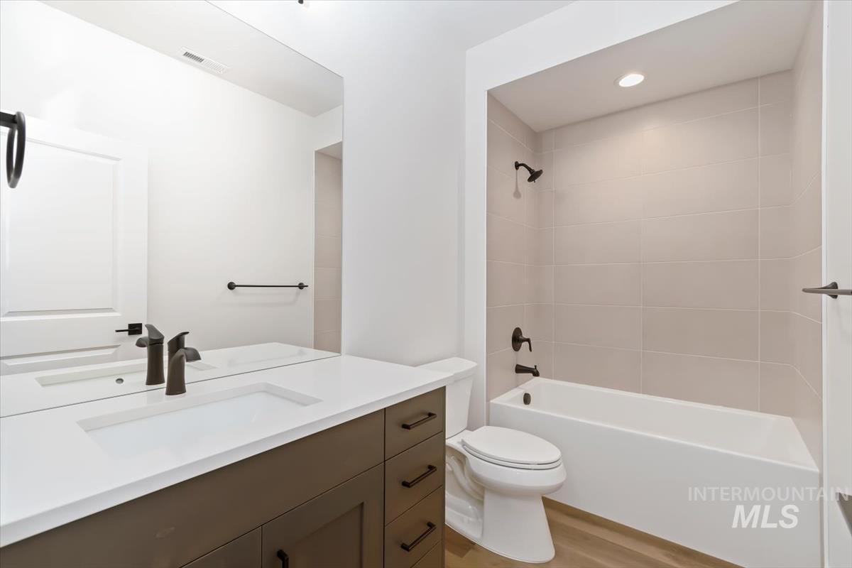 720 South Calhoun Place Star, ID 83669 - Photo 33 of 43 Bathroom featuring bathing tub / shower combination, vanity, and light wood-style flooring
