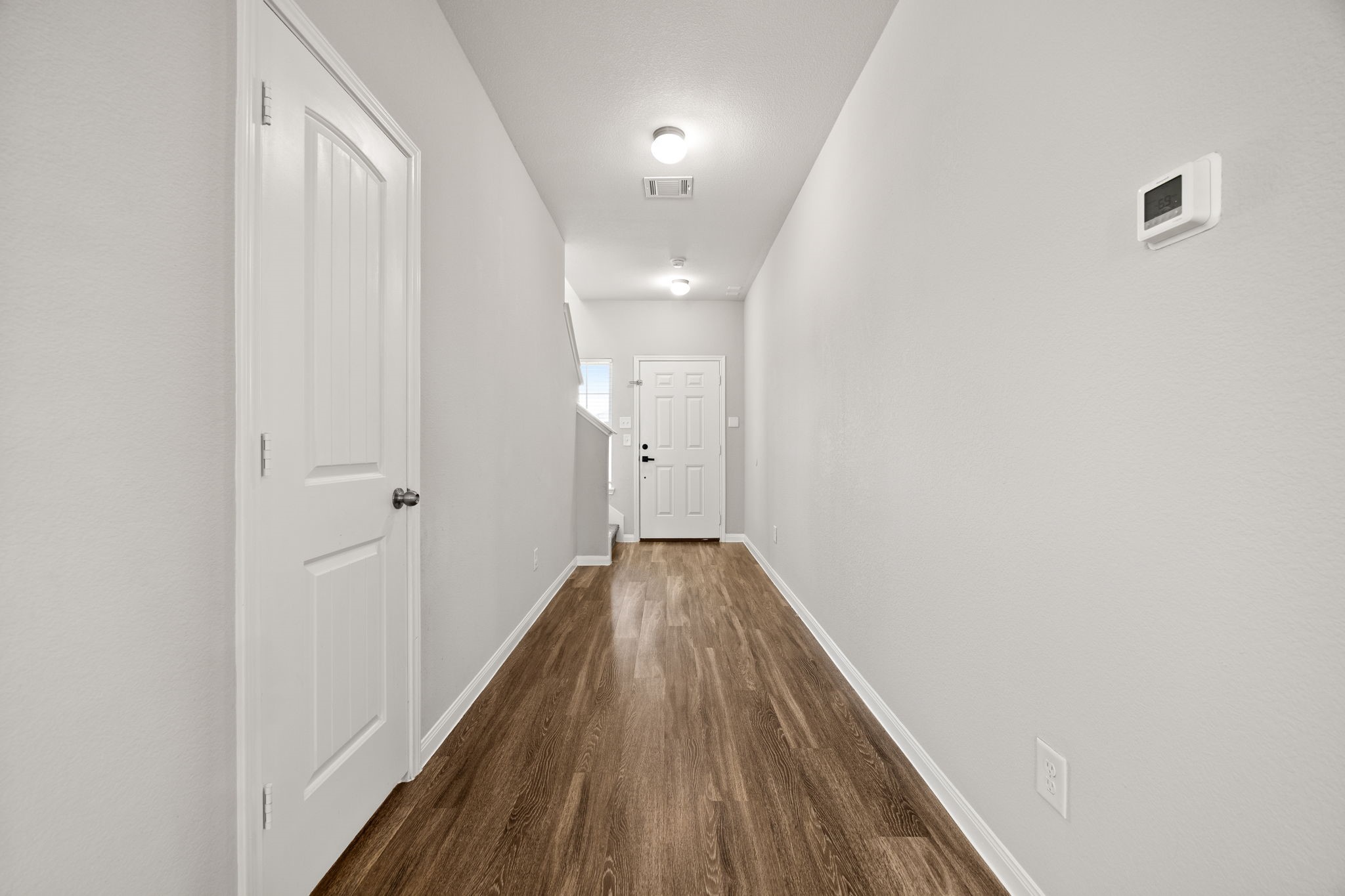 18606 Lansdowne Stream Path Katy, TX 77449 - Photo 12 of 39 a view of a hallway with wooden floor