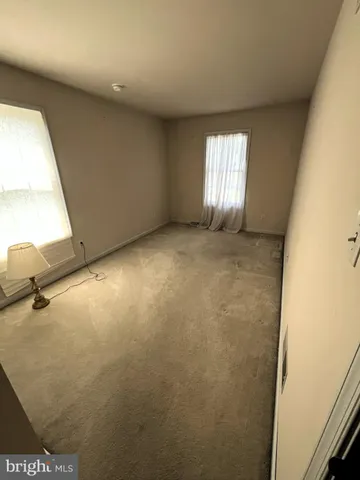 a view of empty room with windows