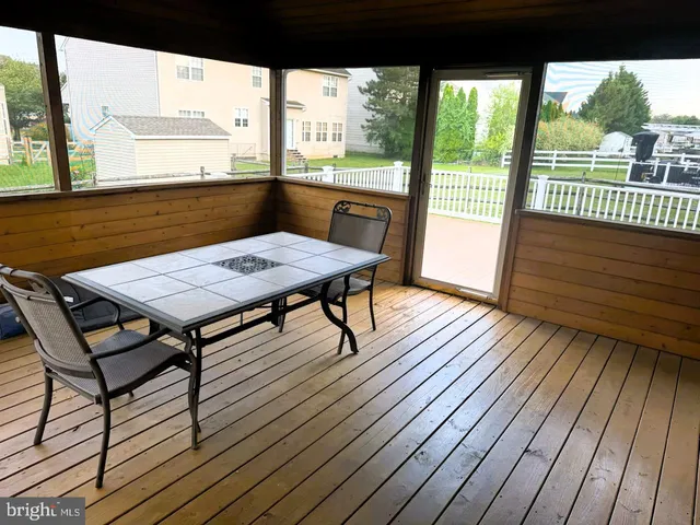 a view of a patio with wooden floor