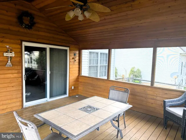 a view of a dining room with a table and chairs