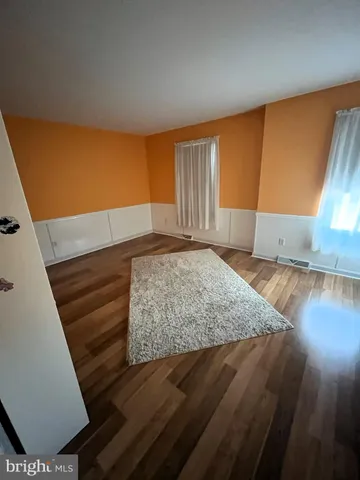 a view of a room with wooden floor