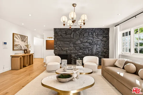 a living room with fireplace furniture and a wooden floor