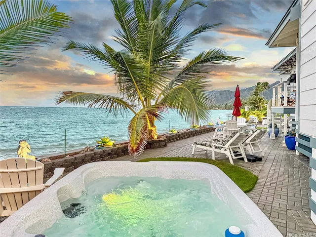 a view of a swimming pool with a patio and a yard