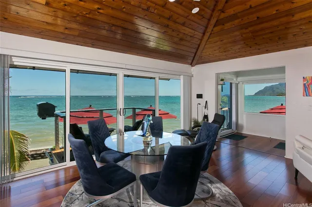a dining room with furniture wooden floor and a chandelier