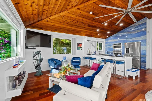 a living room with furniture and wooden floor