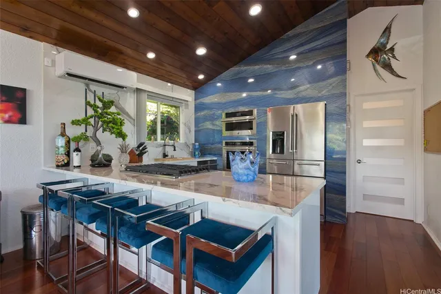 a kitchen with stainless steel appliances granite countertop a sink table and chairs
