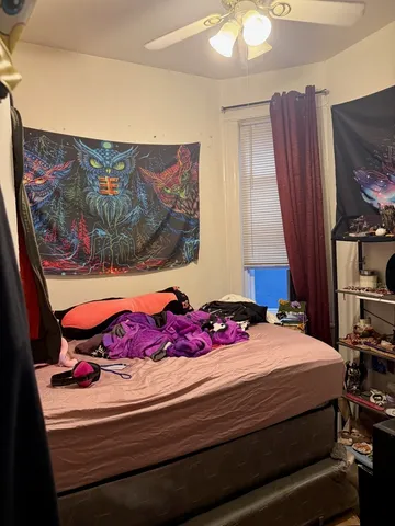 a bedroom with a bed and a window