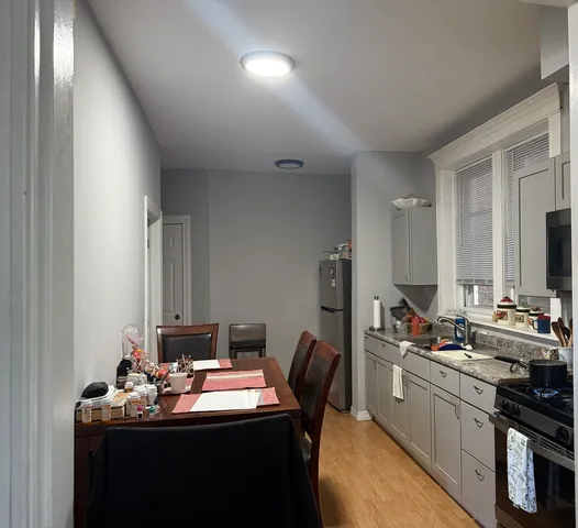 a kitchen with a refrigerator and a stove