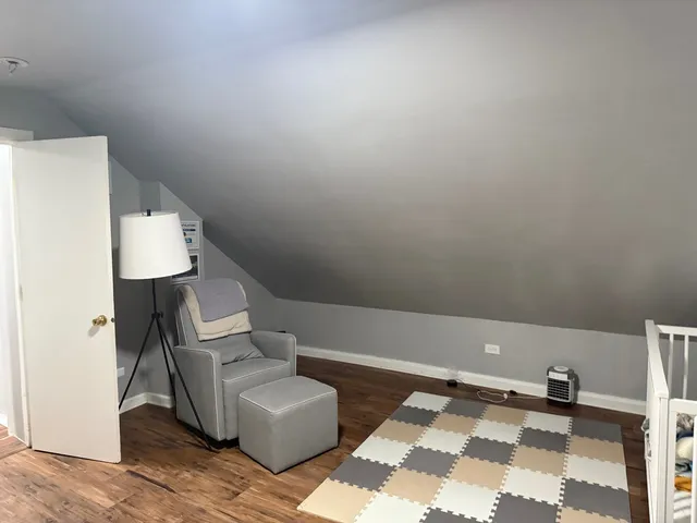 a white toilet sitting next to a white wall